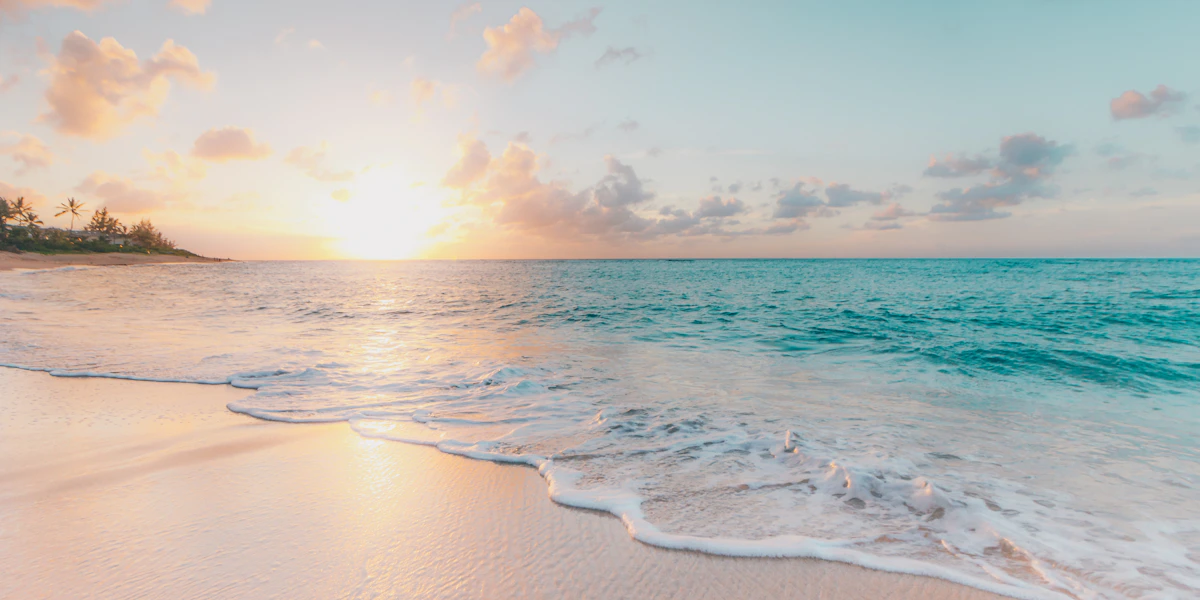 Couple sitting on beach looking away