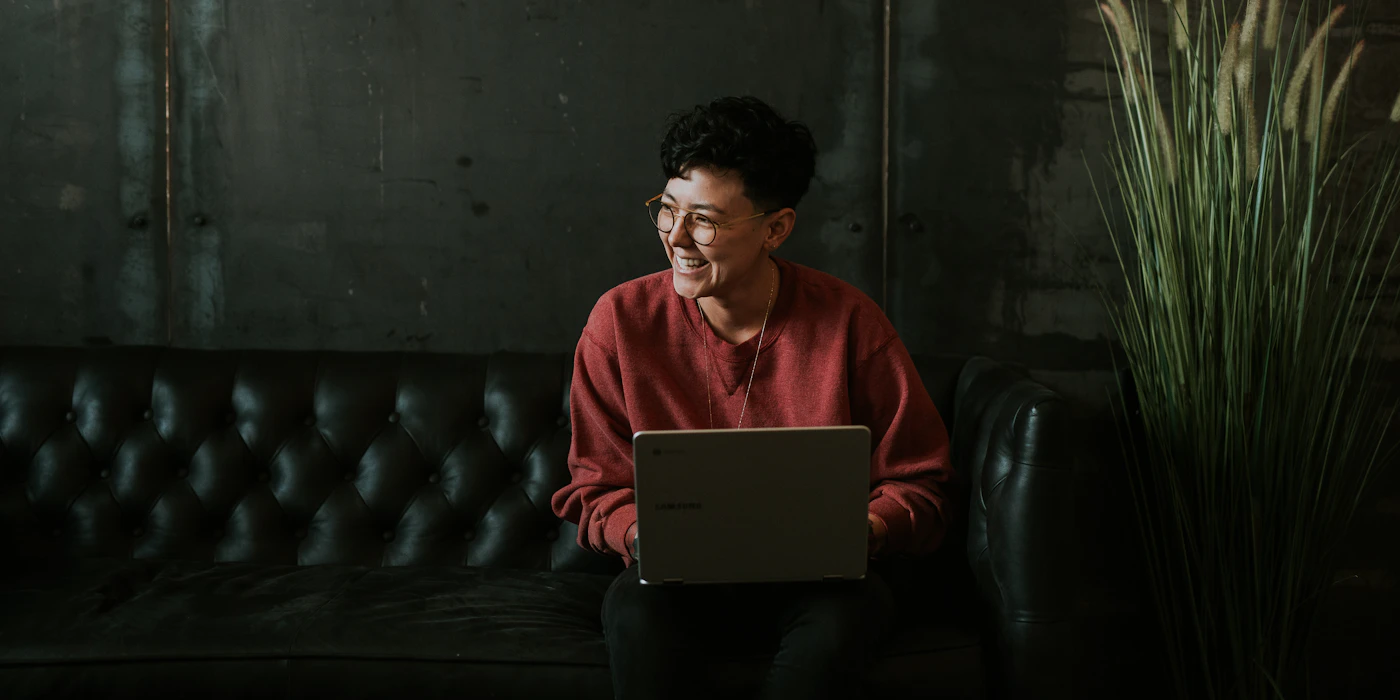 A person at a laptop in soft kitchen light — the everyday act of weighing up whether eharmony is worth the spend